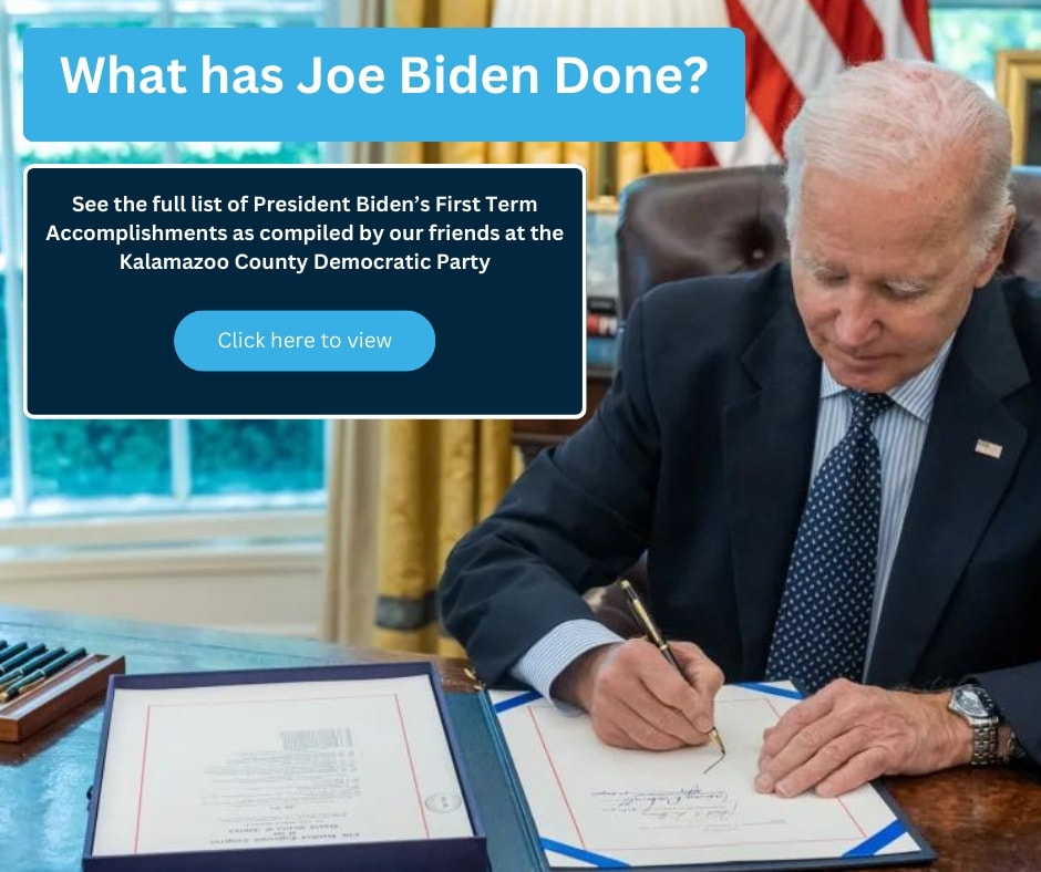 Joe Biden at his desk in the Oval Office signing legislation into law